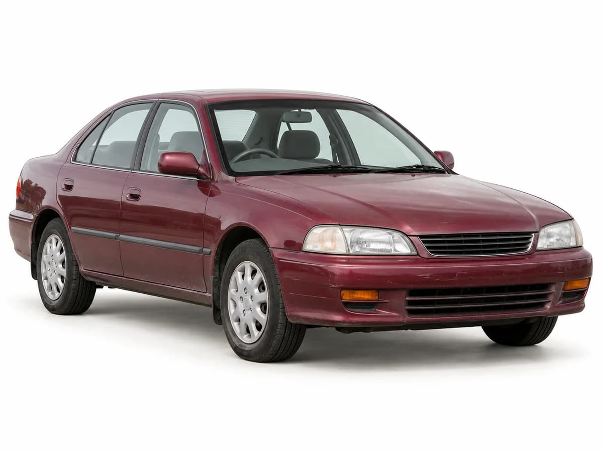 An older burgundy sedan with lightly weathered paint