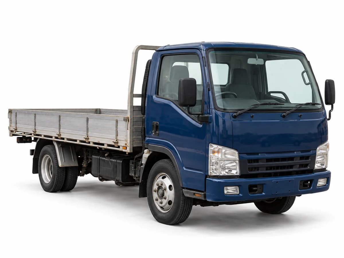 A used blue cab-over tray truck