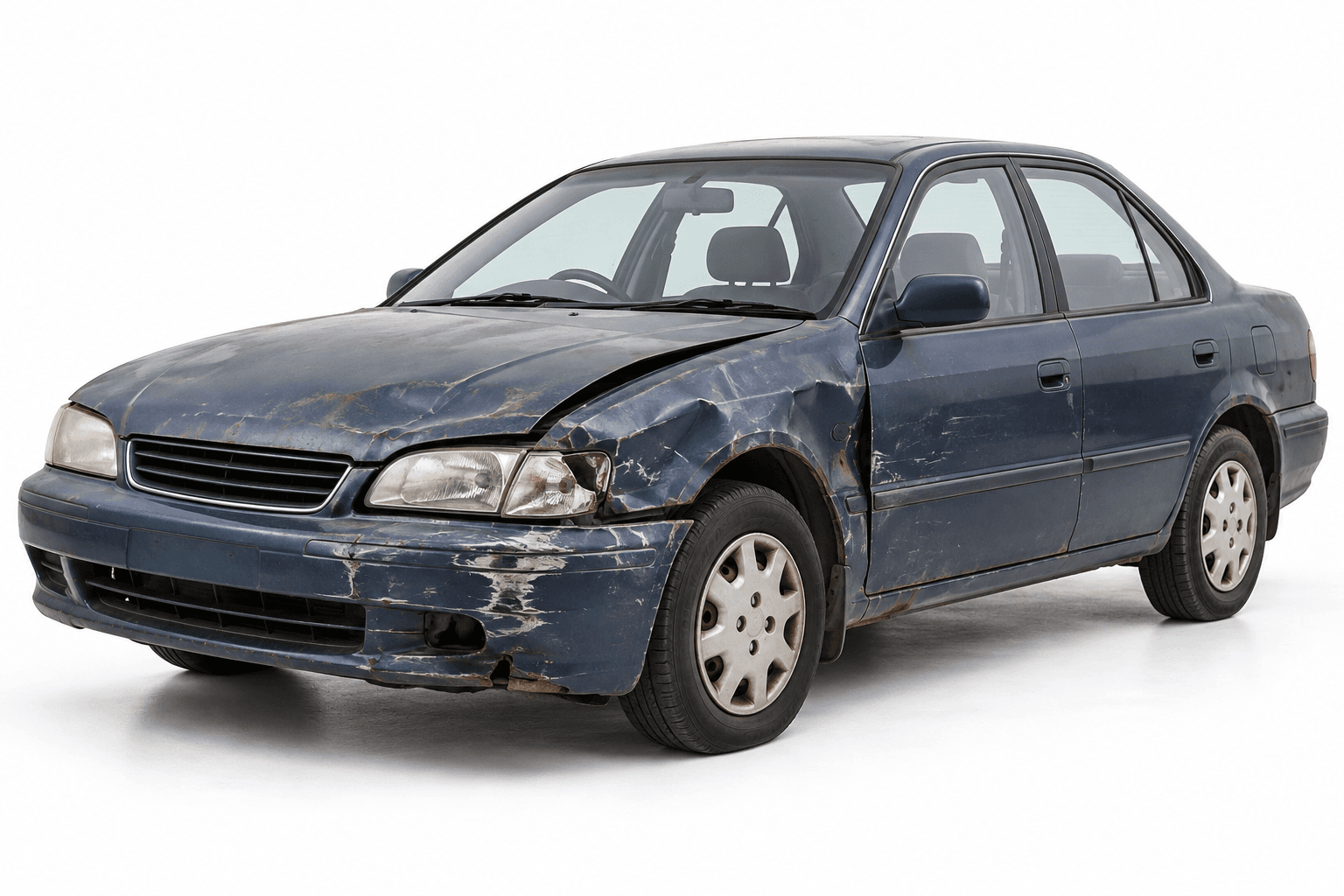 An old blue sedan with dents, worn paint and rust on a white background