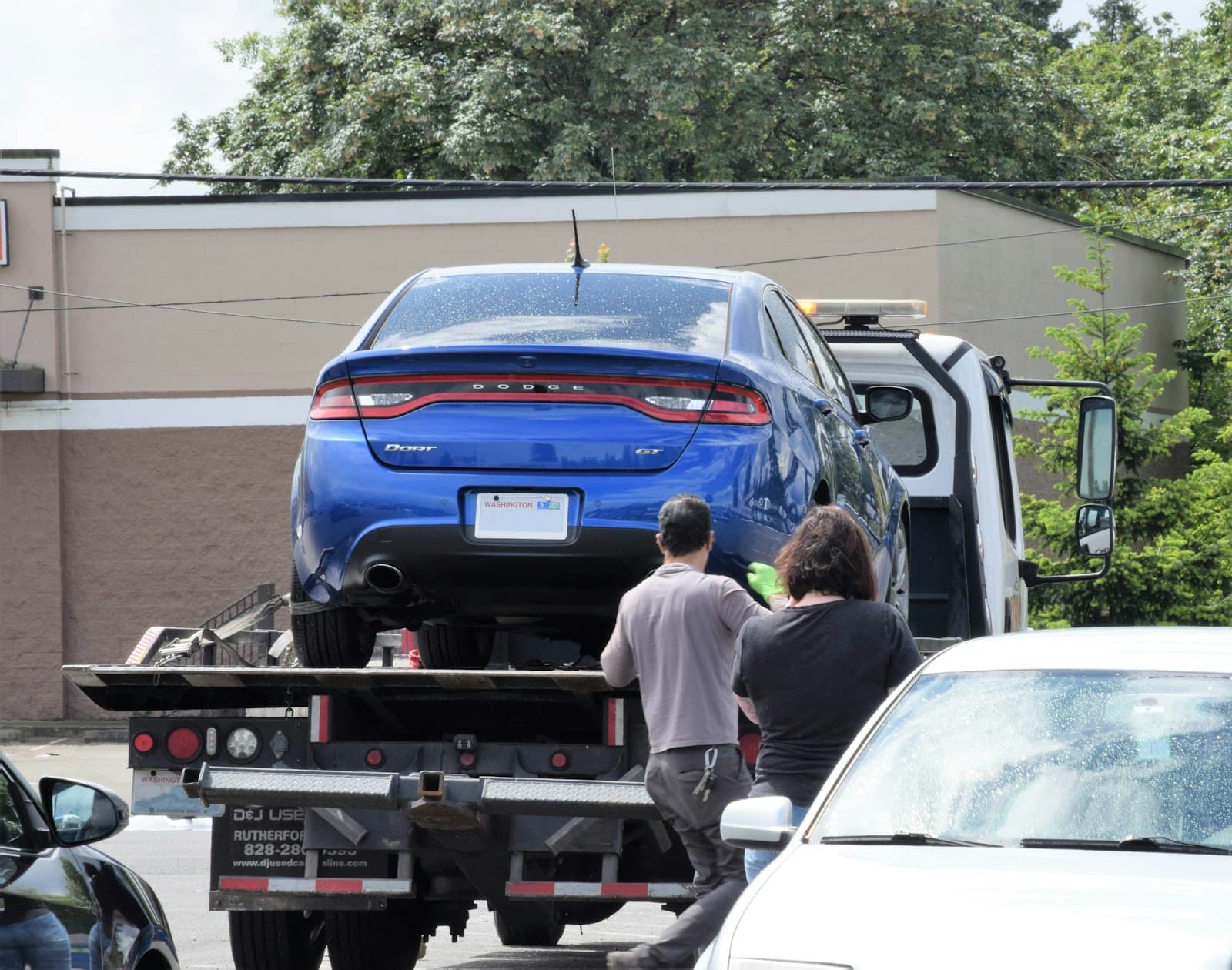 Car being loaded onto a flatbed tow truck