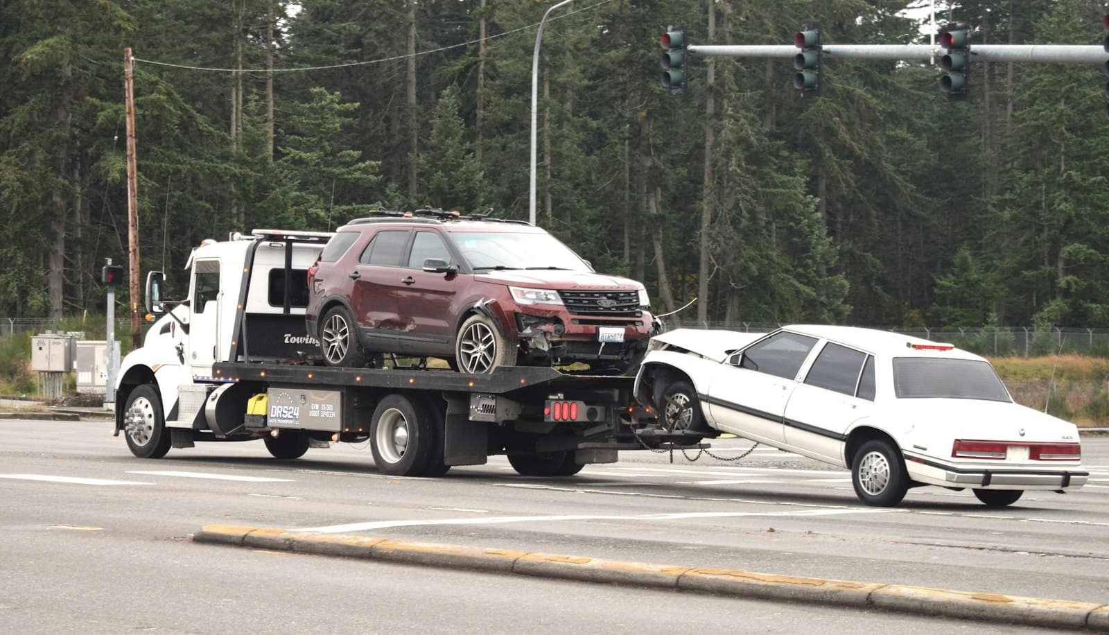 Tow truck carrying a car on the road